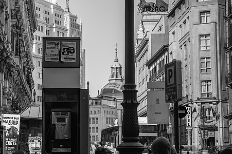 gray scale photo of telephone booth and high rise buildings thumbnail