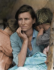 woman wearing green dress shirt while holding baby near two children thumbnail