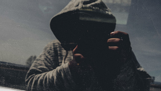 person in gray hoodie sitting on chiar thumbnail