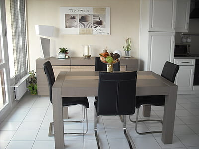 brown dining table with four black chairs thumbnail