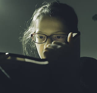 person wearing eyeglasses holding book thumbnail