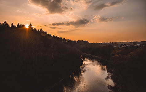 body of water near mountain during golden hour thumbnail
