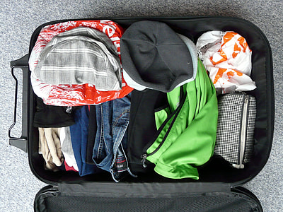 assorted clothes on black luggage bag thumbnail