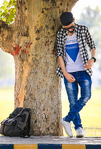 man leaning on tree thumbnail