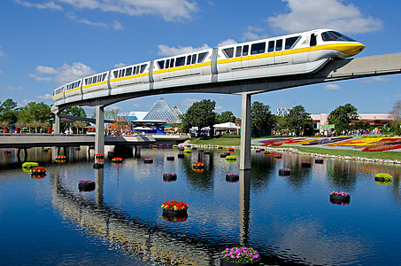 photography of white and yellow train under blue sky at daytime thumbnail