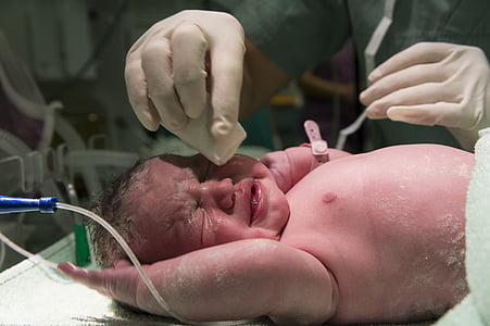 doctor cleaning body of baby thumbnail