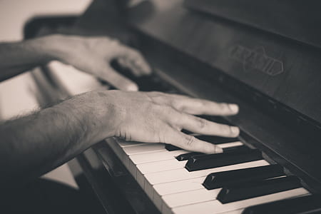 grayscale photo of person playing piano thumbnail