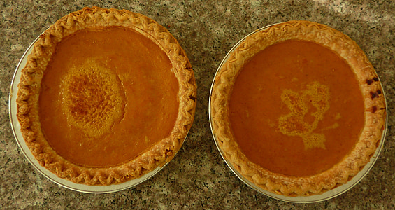 close-up photo of two baked pie on white ceramic plates thumbnail
