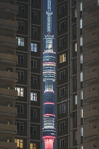 red and gray tower between buildings thumbnail