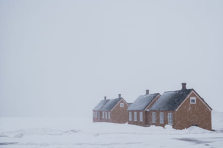 four brown concrete house covered by snow during daytime thumbnail