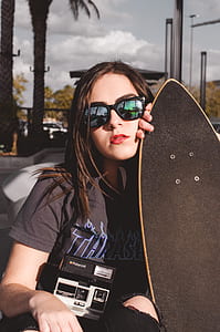 woman holding skateboard thumbnail