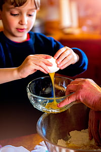 boy breaking an egg over a bowl thumbnail