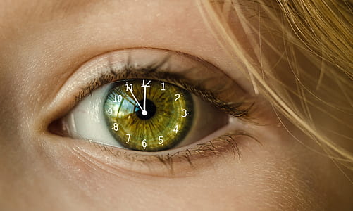 close up edited photo of woman's left eye with analog clock thumbnail