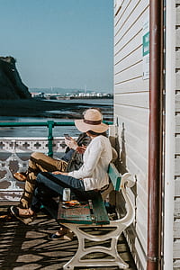 two people talking while sitting on bench thumbnail
