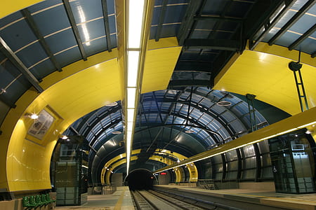 empty yellow, gray, and black train track hallway thumbnail