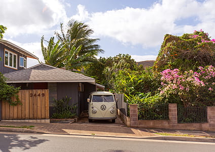 white Volkswagen T2 parked beside brown house on daytime thumbnail