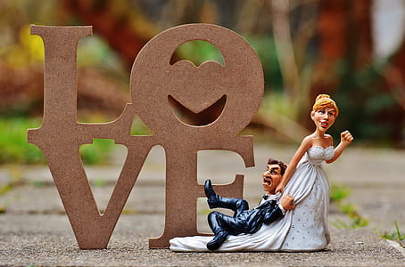male and female couple figurine on concrete surface thumbnail