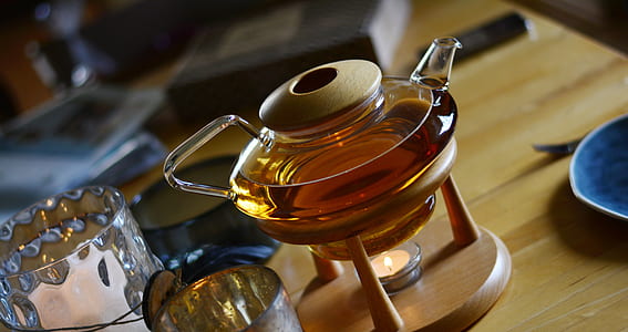clear glass tea pot on wooden rack thumbnail