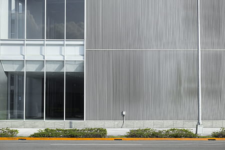 front view of gray and white building beside empty roadway thumbnail