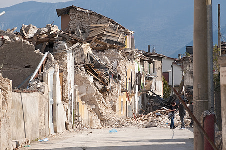three people standing near wrecked building during daytime thumbnail