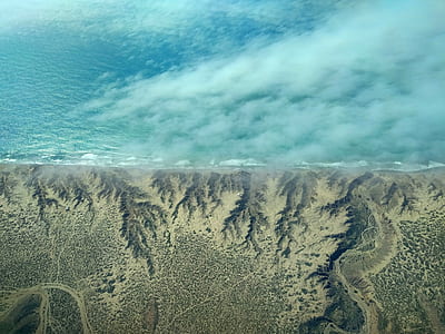 aerial photography of shoreline and body of water thumbnail