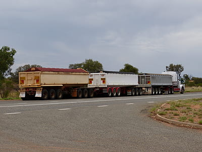 three white freight truck on road at daytime thumbnail