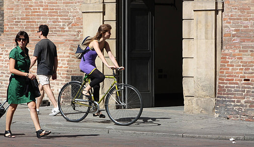 girl riding on bicycle beside the street thumbnail