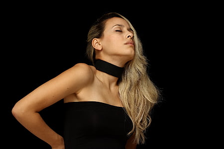 woman in black dress on black background thumbnail