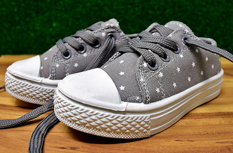 pair of gray low-top sneakers on table top thumbnail