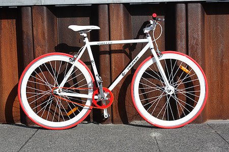 white mountain bike parked on road thumbnail