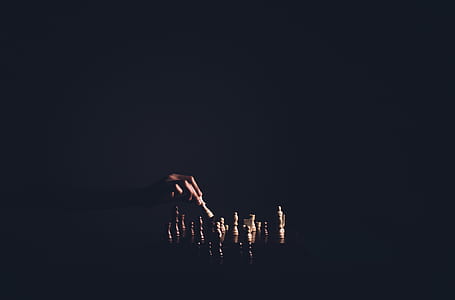 Person Holding Chess Piece thumbnail