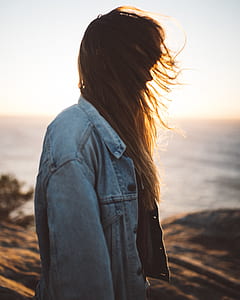 selective focus photography of woman near body of water thumbnail