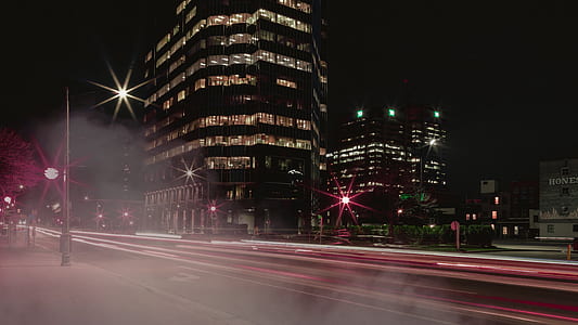 time lapse photography of road and building during nigttime thumbnail