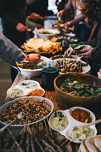 People by a banquet table full with food thumbnail