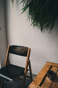 brown and black wooden folding table near white wall thumbnail