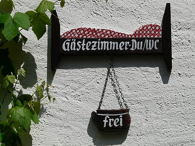 black and white wooden sign on wall thumbnail
