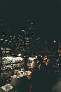 people taking look to paintings on stall thumbnail