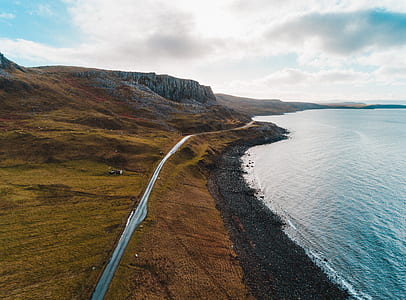 photo of body of water beside shoreline thumbnail