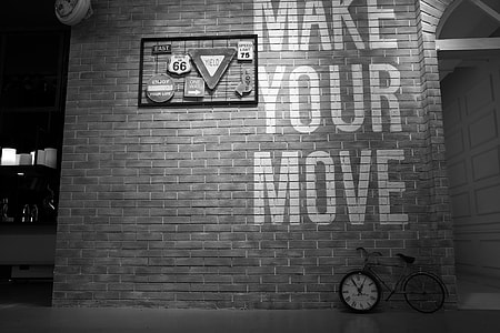 grayscale photo of street signs mounted on wall thumbnail
