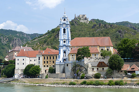 photo of church near body of water and mountain thumbnail