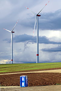 two white windmills under white clouds at daytime thumbnail