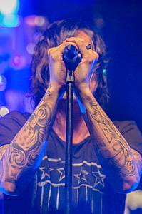 man wearing gray t-shirt in front of microphone thumbnail