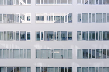 photo of white concrete building with glass windows thumbnail