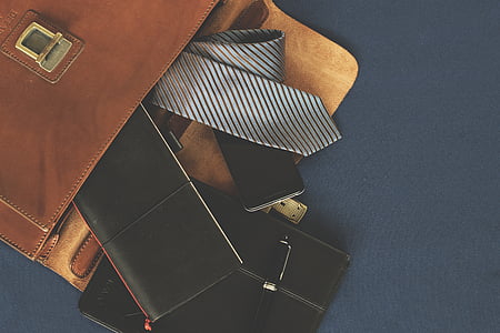 gray and black striped necktie beside black wallet thumbnail