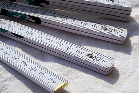 selective focus photography of gray rulers on white textile thumbnail