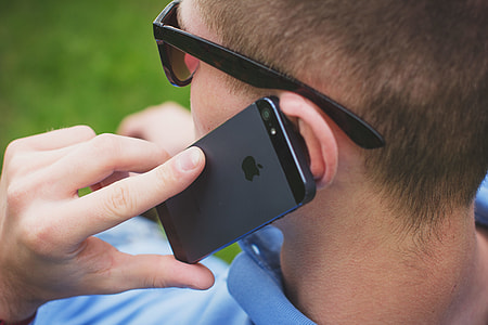 selective focus photography of person using iPhone thumbnail