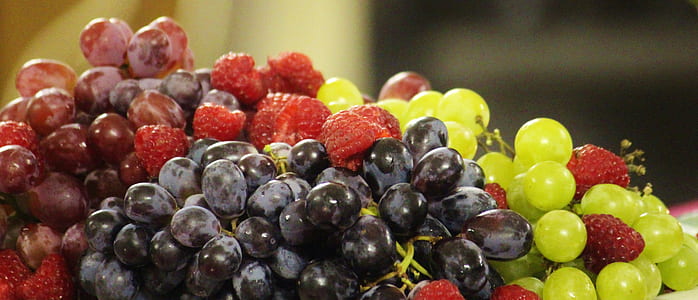 shallow focus photography of grapes and raspberries thumbnail