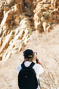 selective focus photography of person capturing plants thumbnail