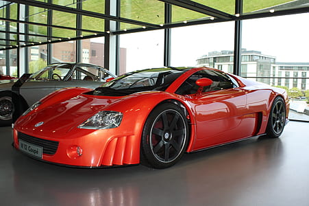 red sports coupe on show room thumbnail