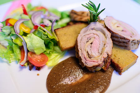 Roasted Meat on a Gravy Beside a Garden Salad thumbnail